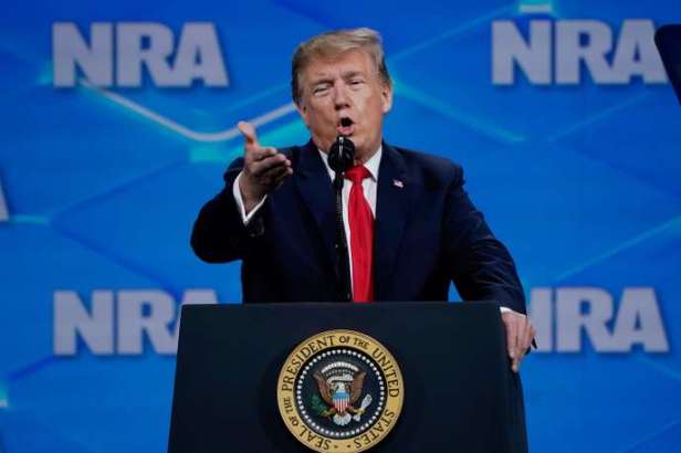 US President Donald Trump assesses those gathered at the annual National Rifle Association (NRA) convention in Indianapolis, Indiana